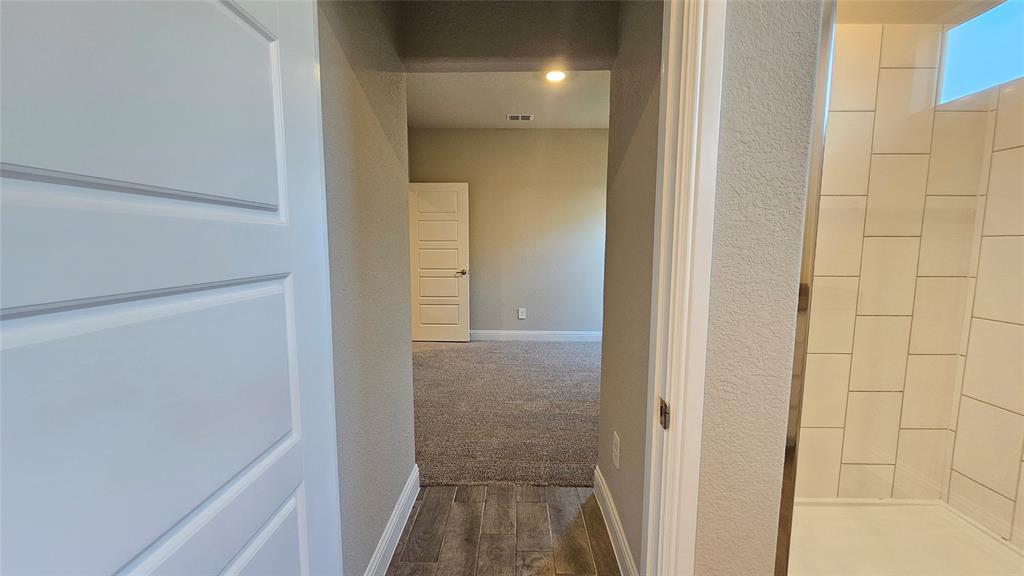 1405 Razorbill Road Denton, TX 76205 - Photo 27 of 40 a view of a bathroom from a hallway