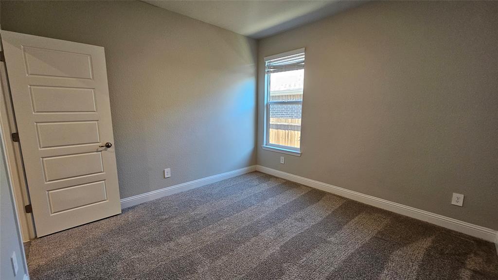 1405 Razorbill Road Denton, TX 76205 - Photo 28 of 40 a view of an empty room with a window