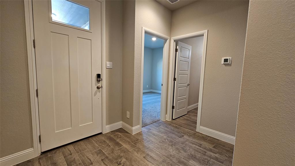 1405 Razorbill Road Denton, TX 76205 - Photo 32 of 40 an empty room with wooden floor