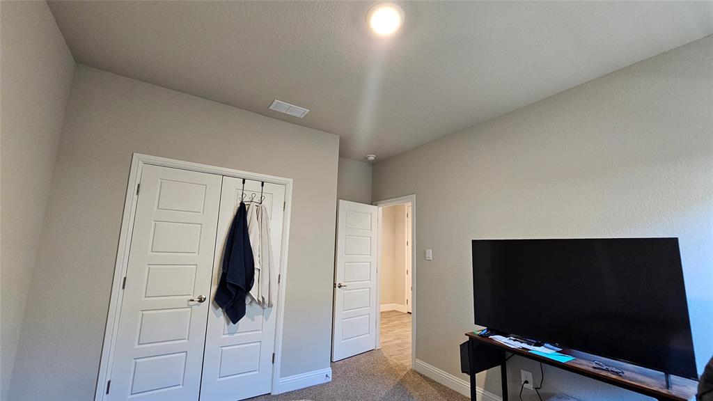 1405 Razorbill Road Denton, TX 76205 - Photo 38 of 40 a room with furniture and a flat screen tv