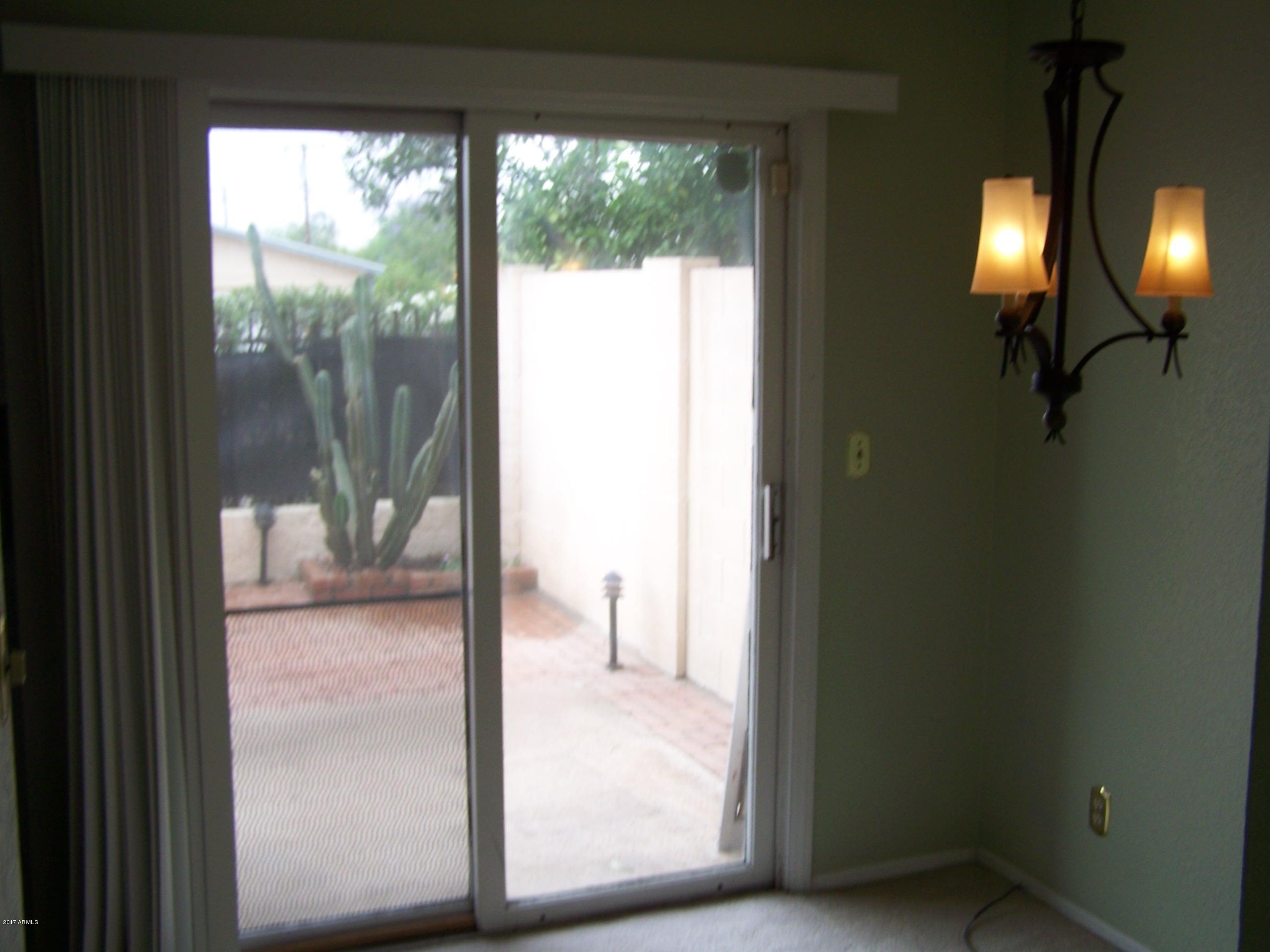 1402 East Osborn Road, Unit 16 Phoenix, AZ 85014 - Photo 10 of 15 a view of a glass door and a living room