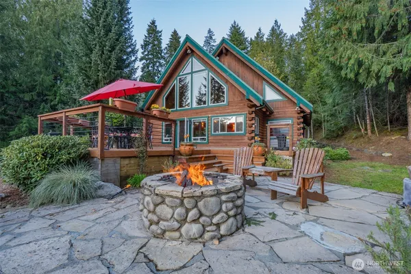a backyard of a house with yard and outdoor seating