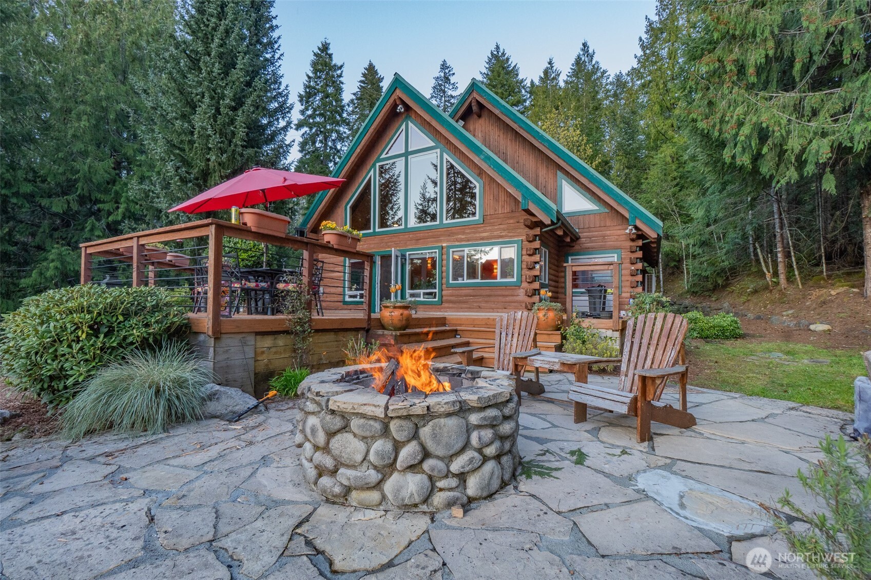 6323 North Lake Cushman Road Hoodsport, WA 98548 - Photo 1 of 40 a backyard of a house with yard and outdoor seating