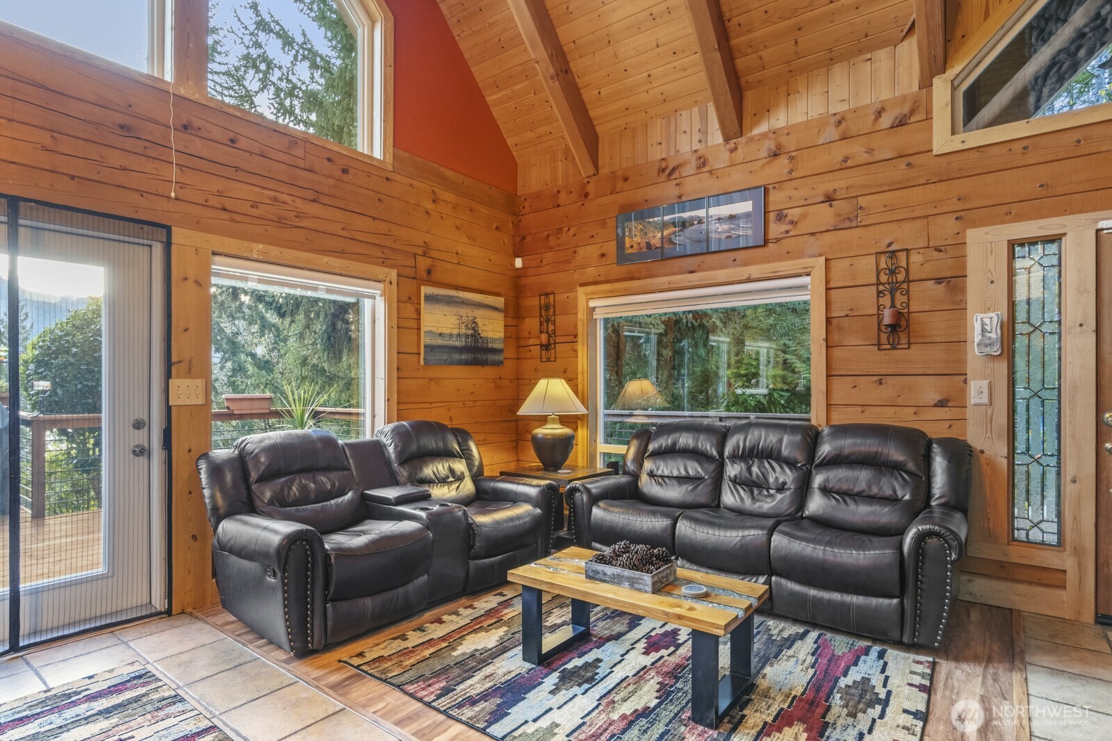6323 North Lake Cushman Road Hoodsport, WA 98548 - Photo 15 of 40 a living room with furniture a flat screen tv and a window