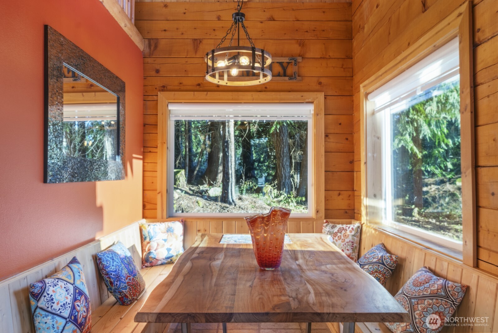 6323 North Lake Cushman Road Hoodsport, WA 98548 - Photo 16 of 40 a view of a dining room with furniture a chandelier and wooden floor