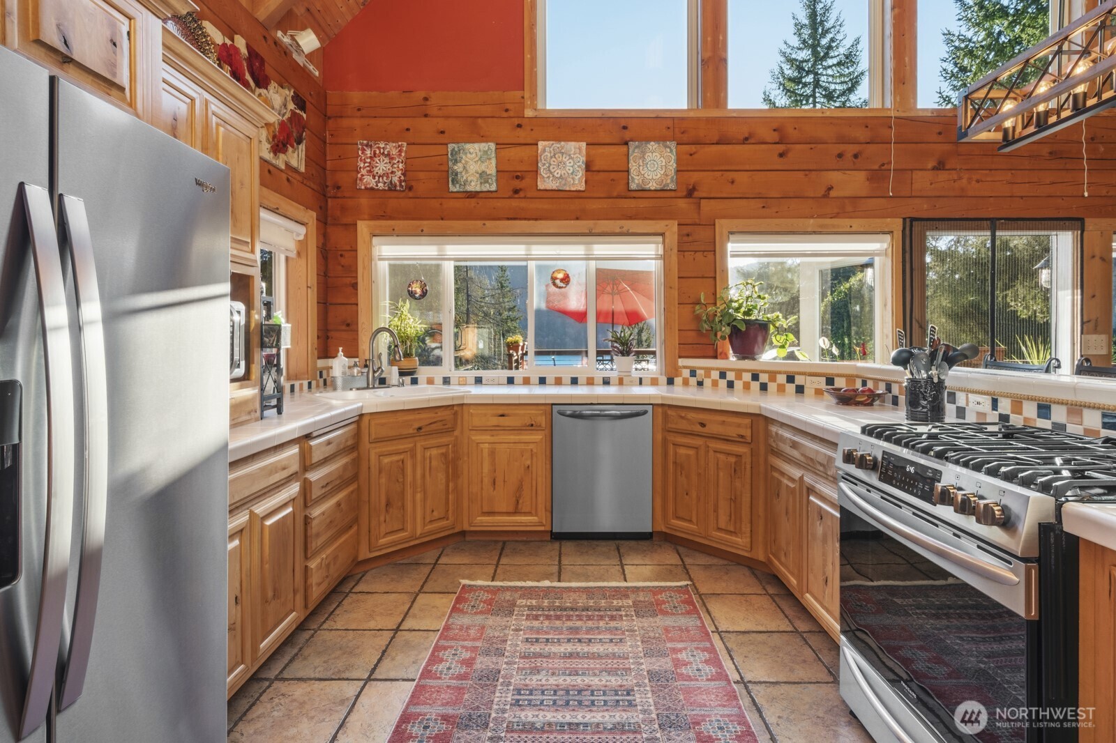 6323 North Lake Cushman Road Hoodsport, WA 98548 - Photo 17 of 40 a kitchen with stainless steel appliances granite countertop a sink stove and refrigerator