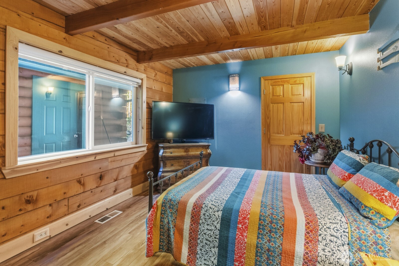 6323 North Lake Cushman Road Hoodsport, WA 98548 - Photo 20 of 40 a bedroom with a bed and a flat screen tv