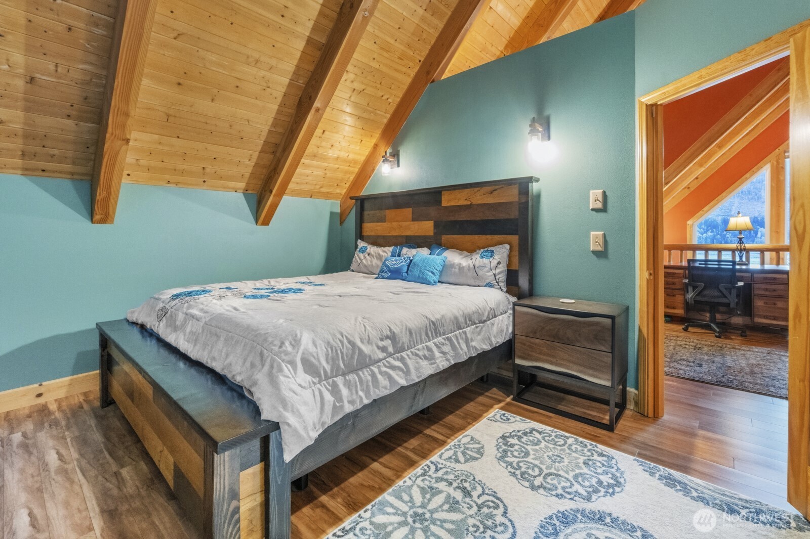 6323 North Lake Cushman Road Hoodsport, WA 98548 - Photo 30 of 40 a bedroom with a bed and wooden floor