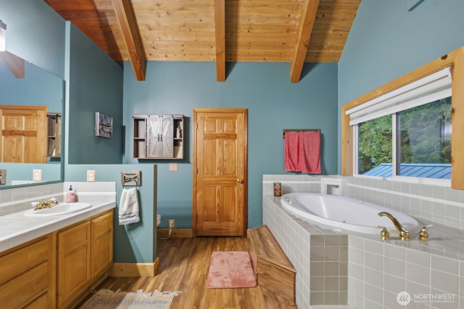 6323 North Lake Cushman Road Hoodsport, WA 98548 - Photo 31 of 40 a bathroom with a tub sink and a washing machine