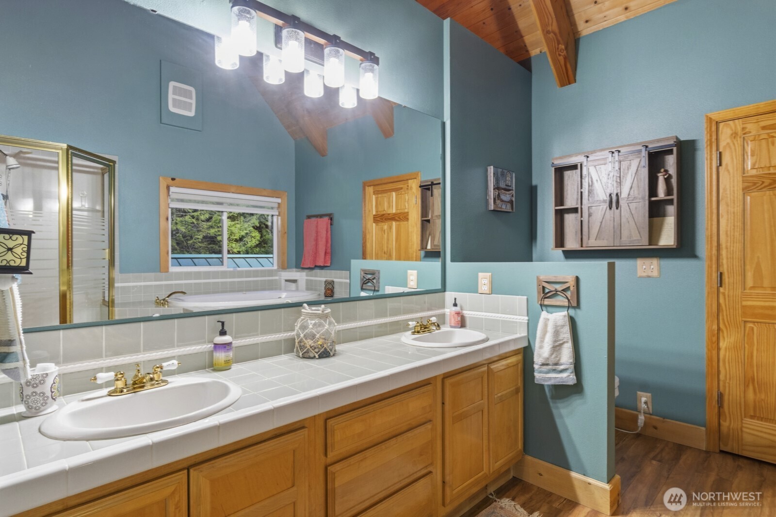 6323 North Lake Cushman Road Hoodsport, WA 98548 - Photo 32 of 40 a bathroom with a double vanity sink and a mirror