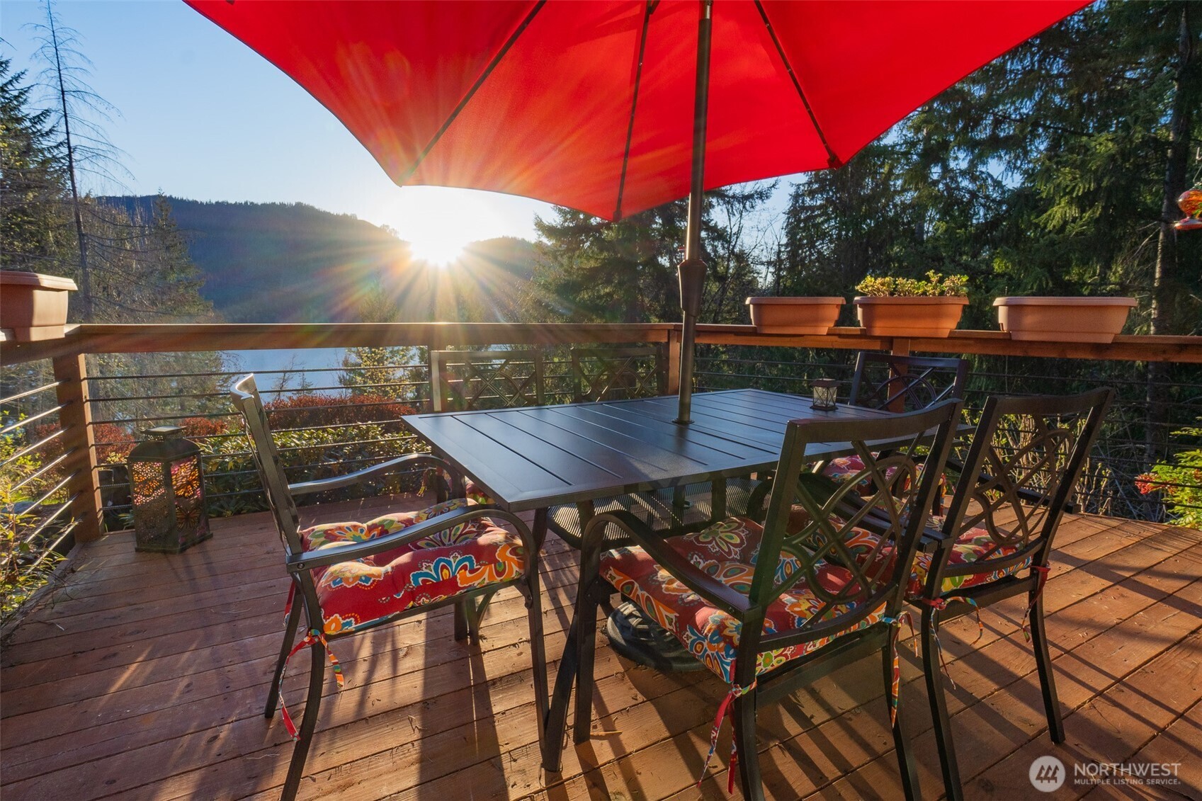 6323 North Lake Cushman Road Hoodsport, WA 98548 - Photo 6 of 40 a view of a roof deck with table and chairs under an umbrella