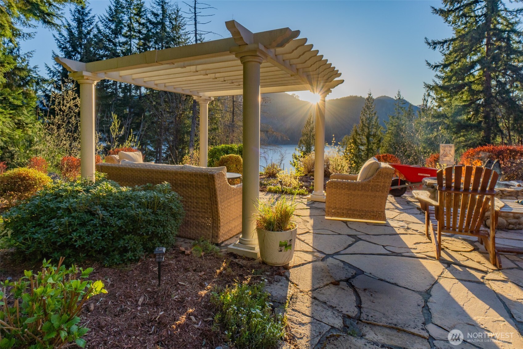 6323 North Lake Cushman Road Hoodsport, WA 98548 - Photo 7 of 40 a view of a patio with table and chairs potted plants