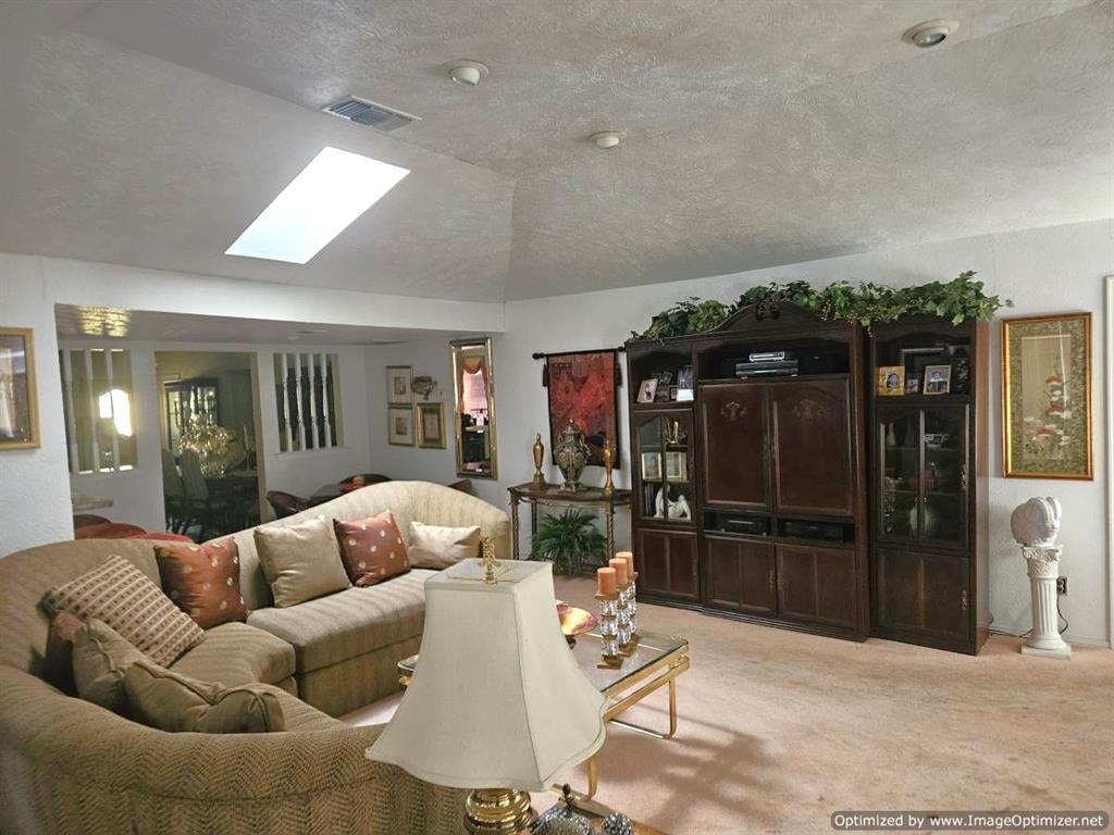 7510 Ridgewick Drive Dallas, TX 75217 - Photo 2 of 21 Main living room with games or dining area in far corner of photo