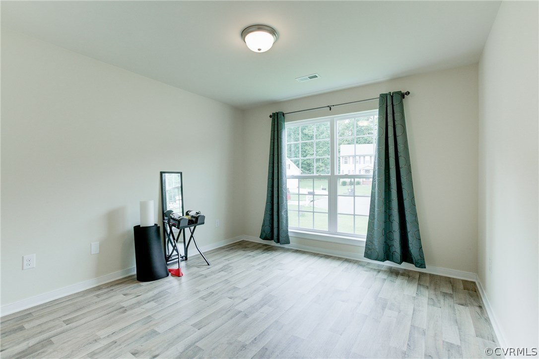 9607 Gdn Rdg Trace Chesterfield, VA 23832 - Photo 19 of 25 an empty room with wooden floor and windows