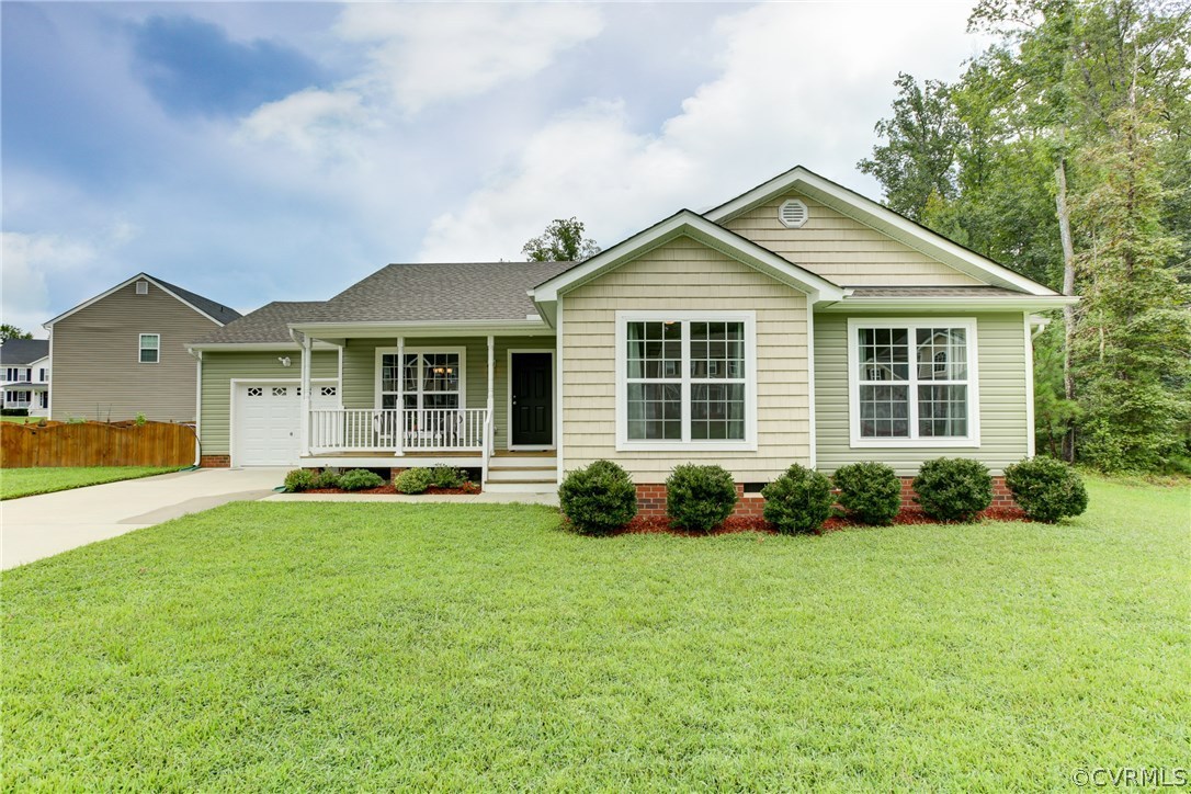 9607 Gdn Rdg Trace Chesterfield, VA 23832 - Photo 3 of 25 a front view of a house with a yard and porch