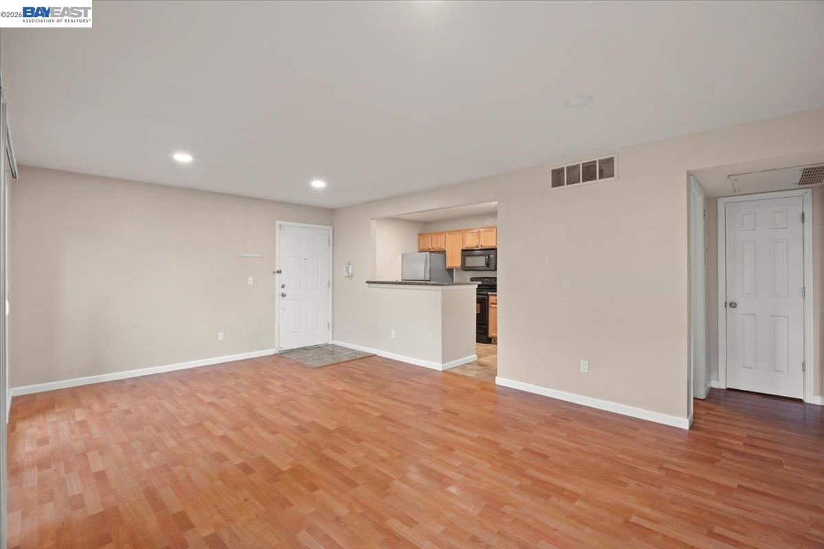 215 Reflections Drive, Unit 16 San Ramon, CA 94583 - Photo 4 of 17 a view of a big room with wooden floor and kitchen view