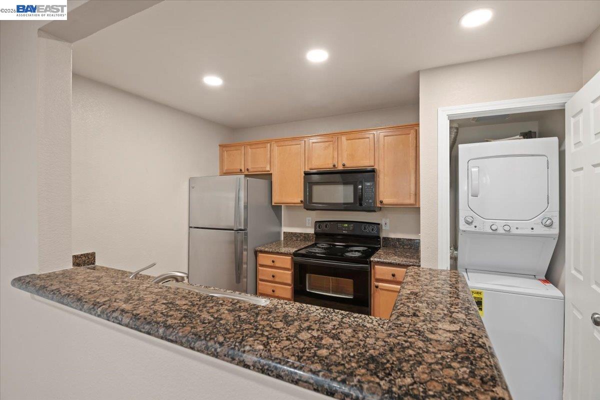 215 Reflections Drive, Unit 16 San Ramon, CA 94583 - Photo 5 of 17 a kitchen with stainless steel appliances granite countertop a refrigerator and a stove top oven