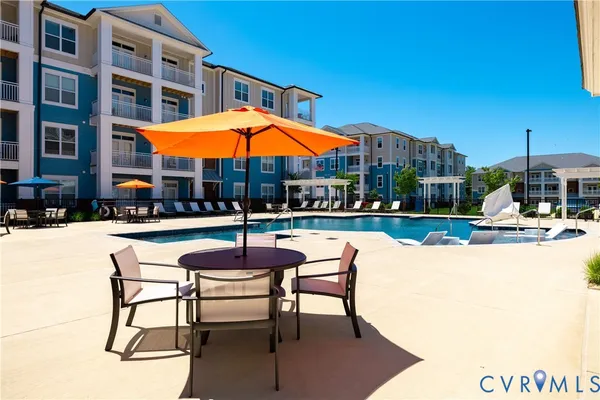 a swimming pool with outdoor seating and yard