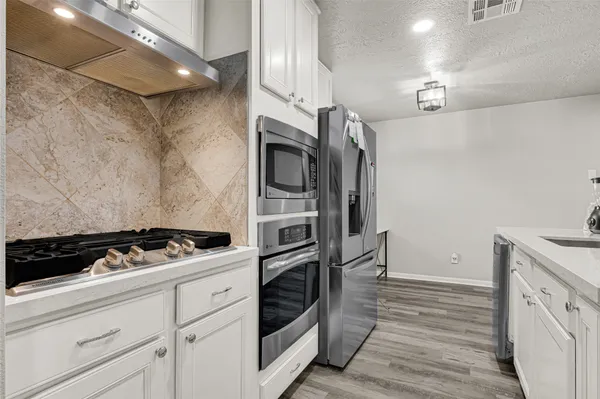 a kitchen with granite countertop a stove and a sink