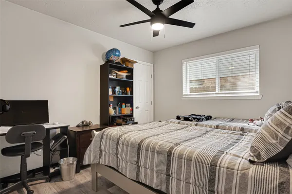 a bedroom with a bed and a tv