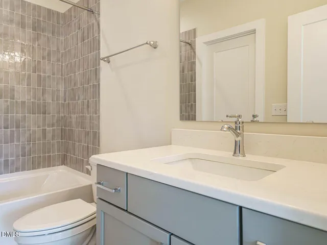 a bathroom with a sink a toilet and bathtub