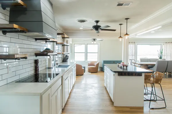 a kitchen with kitchen island granite countertop a sink a counter space and cabinets