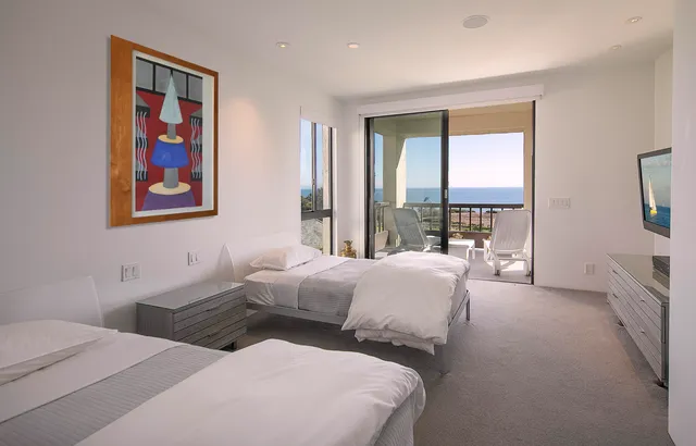 a view of a pathway both side of grassy field with shrub