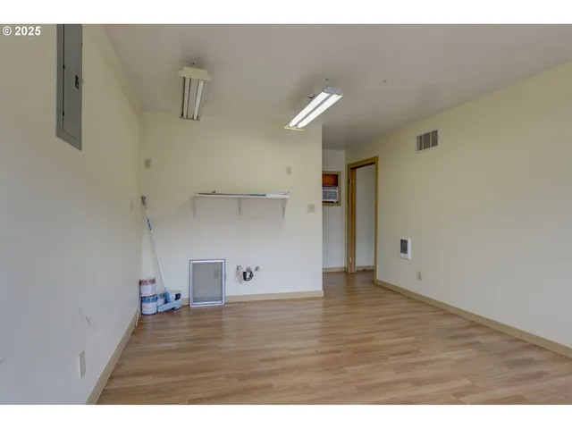 a view of empty room with wooden floor