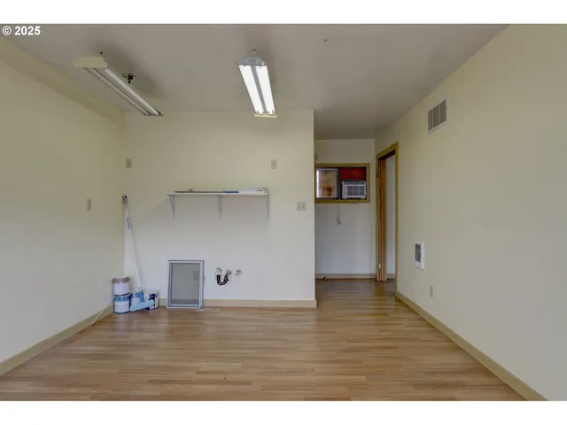 a view of empty room with wooden floor