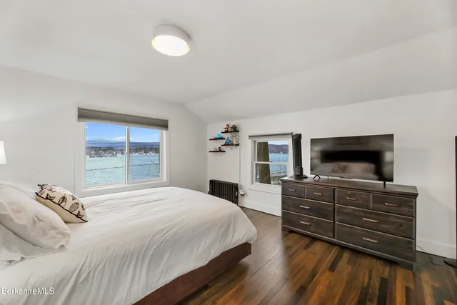 a bedroom with a bed and a television