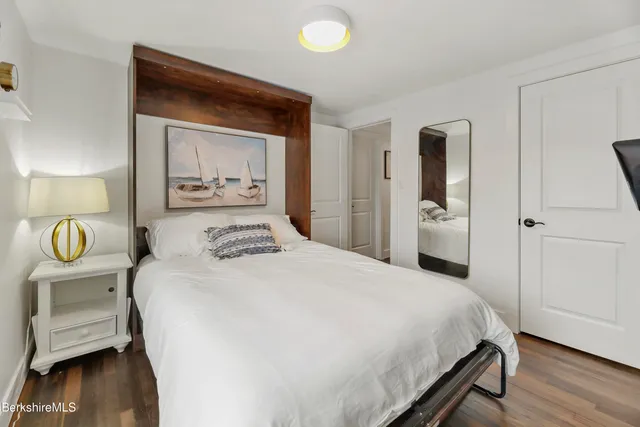 a bedroom with a bed and a view of living room