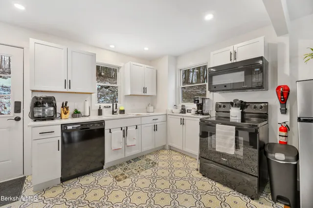 a kitchen with stainless steel appliances granite countertop a sink and cabinets