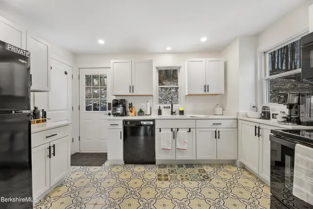 a kitchen with granite countertop a sink stove and refrigerator