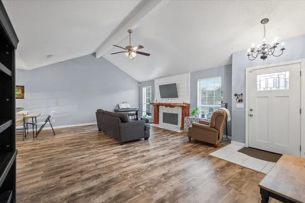 a living room with furniture fireplace and flat screen tv