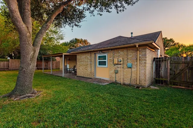 a front view of a house with a yard and trees