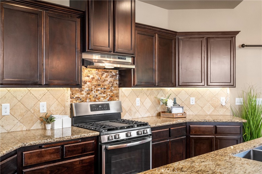 2775 Levi Lane Chico, CA 95973 - Photo 15 of 34 a kitchen with granite countertop a stove and cabinets