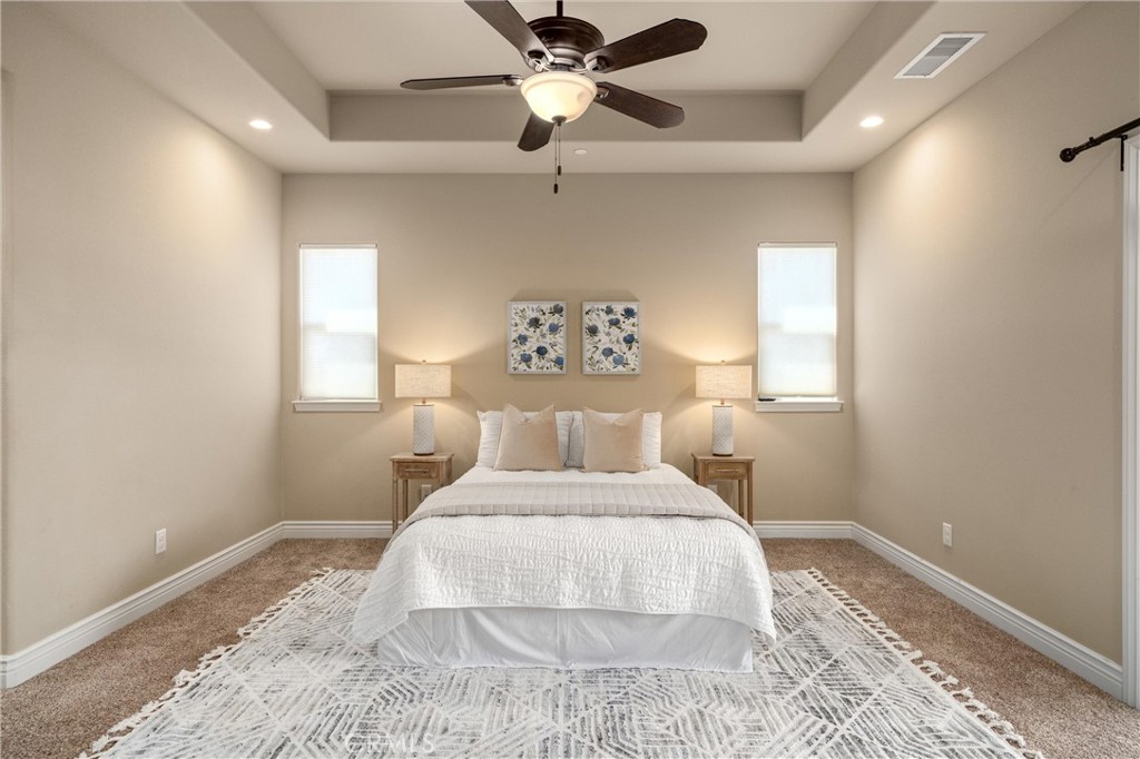 2775 Levi Lane Chico, CA 95973 - Photo 22 of 34 a bedroom with a bed and a chandelier