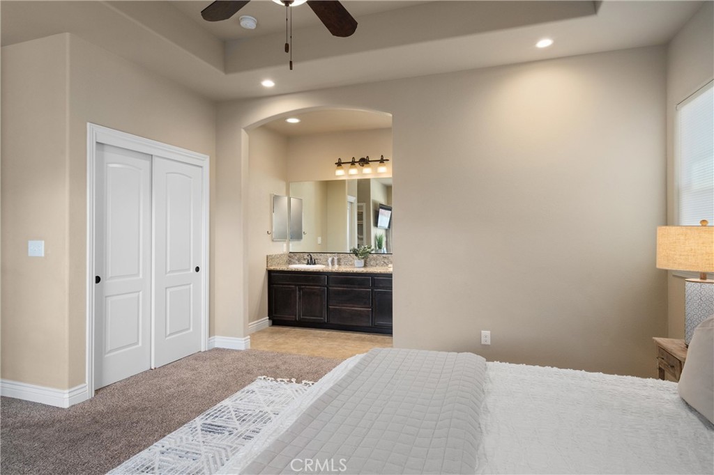 2775 Levi Lane Chico, CA 95973 - Photo 24 of 34 a bedroom with a bed and a chandelier
