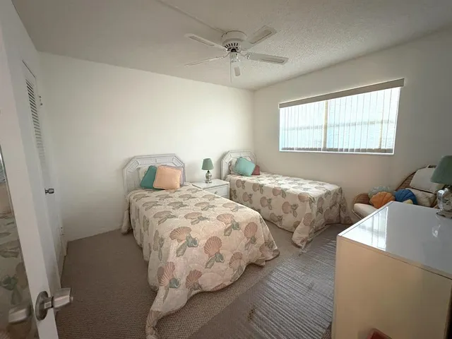 a bedroom with two beds and a window