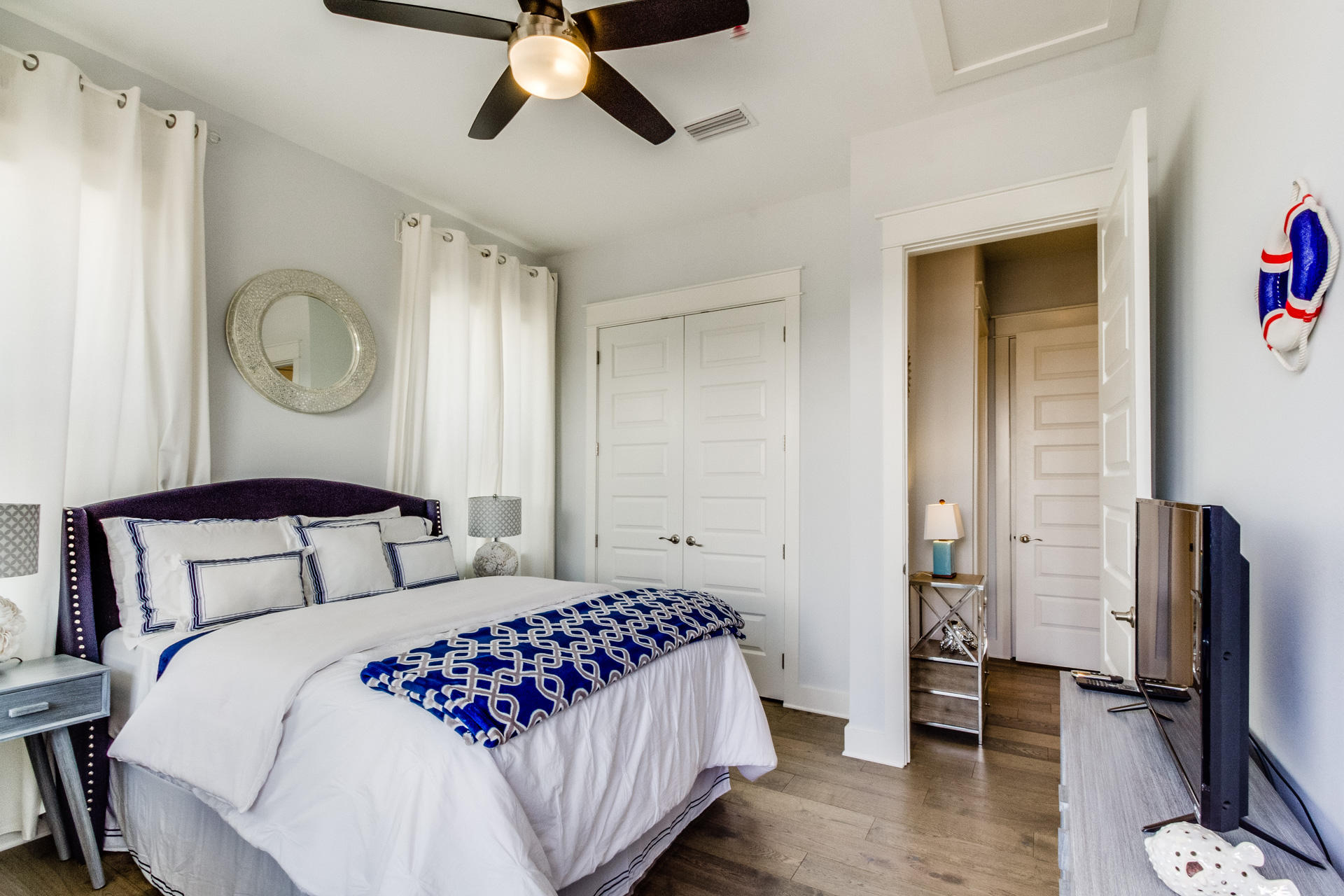 10 York Ln Inlet Beach, Unit C289 Inlet Beach, FL 32461 - Photo 18 of 32 a bedroom with a large bed and a chandelier