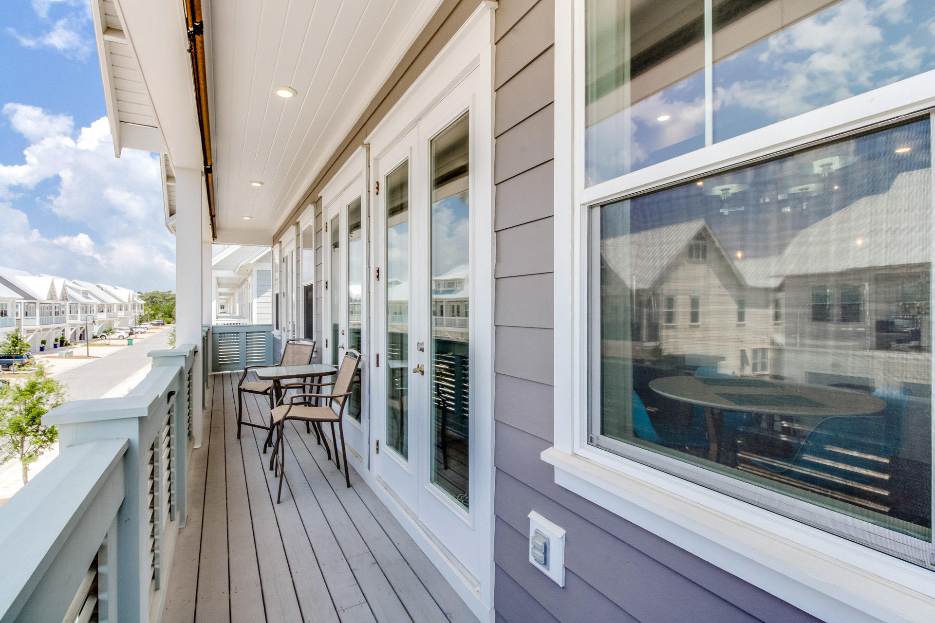 10 York Ln Inlet Beach, Unit C289 Inlet Beach, FL 32461 - Photo 22 of 32 a view of a balcony with chairs and wooden floor
