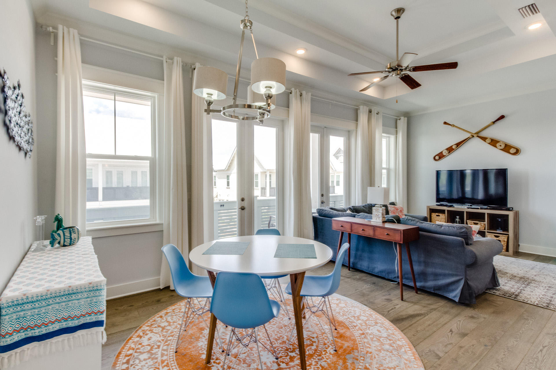 10 York Ln Inlet Beach, Unit C289 Inlet Beach, FL 32461 - Photo 5 of 32 a living room with furniture a chandelier and a table