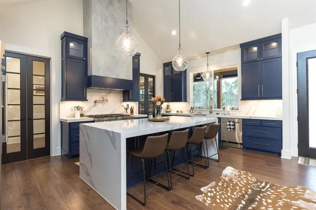 a large kitchen with a table and chairs