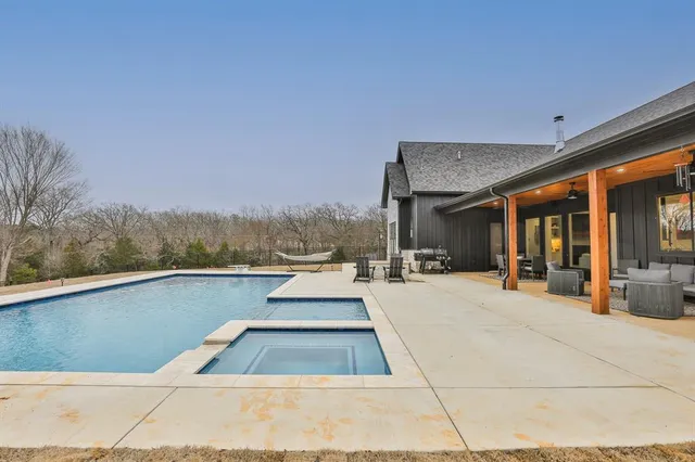a view of swimming pool with seating area