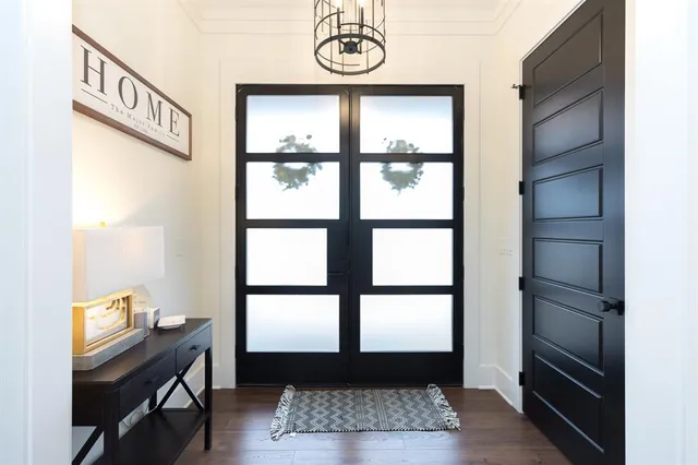 a view of entryway with a window and wooden floor
