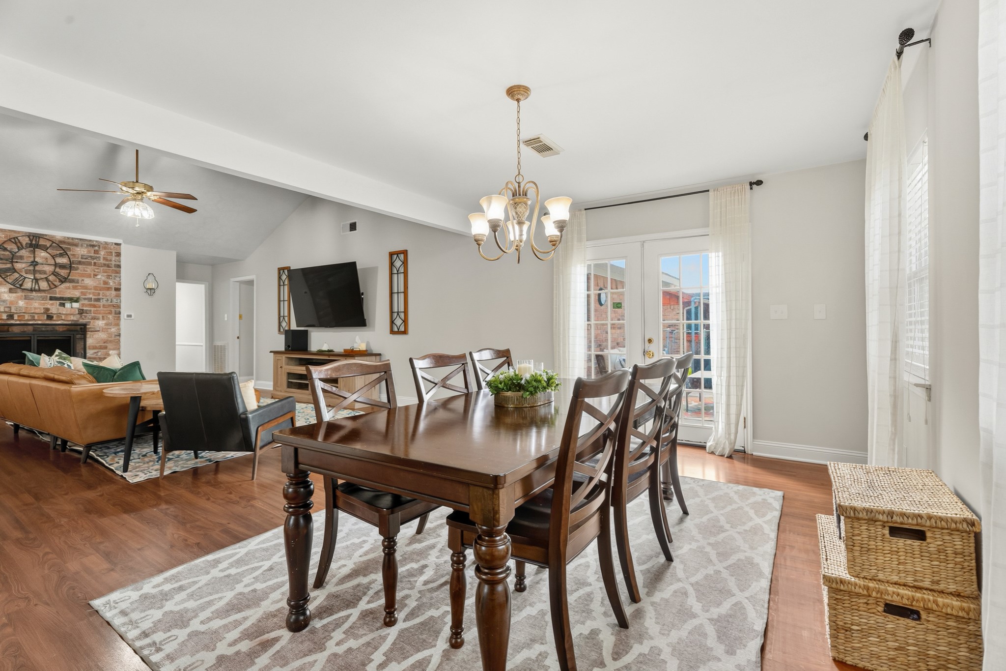 2104 Rose Road Pearland, TX 77581 - Photo 18 of 43 a dining room with furniture a chandelier and wooden floor