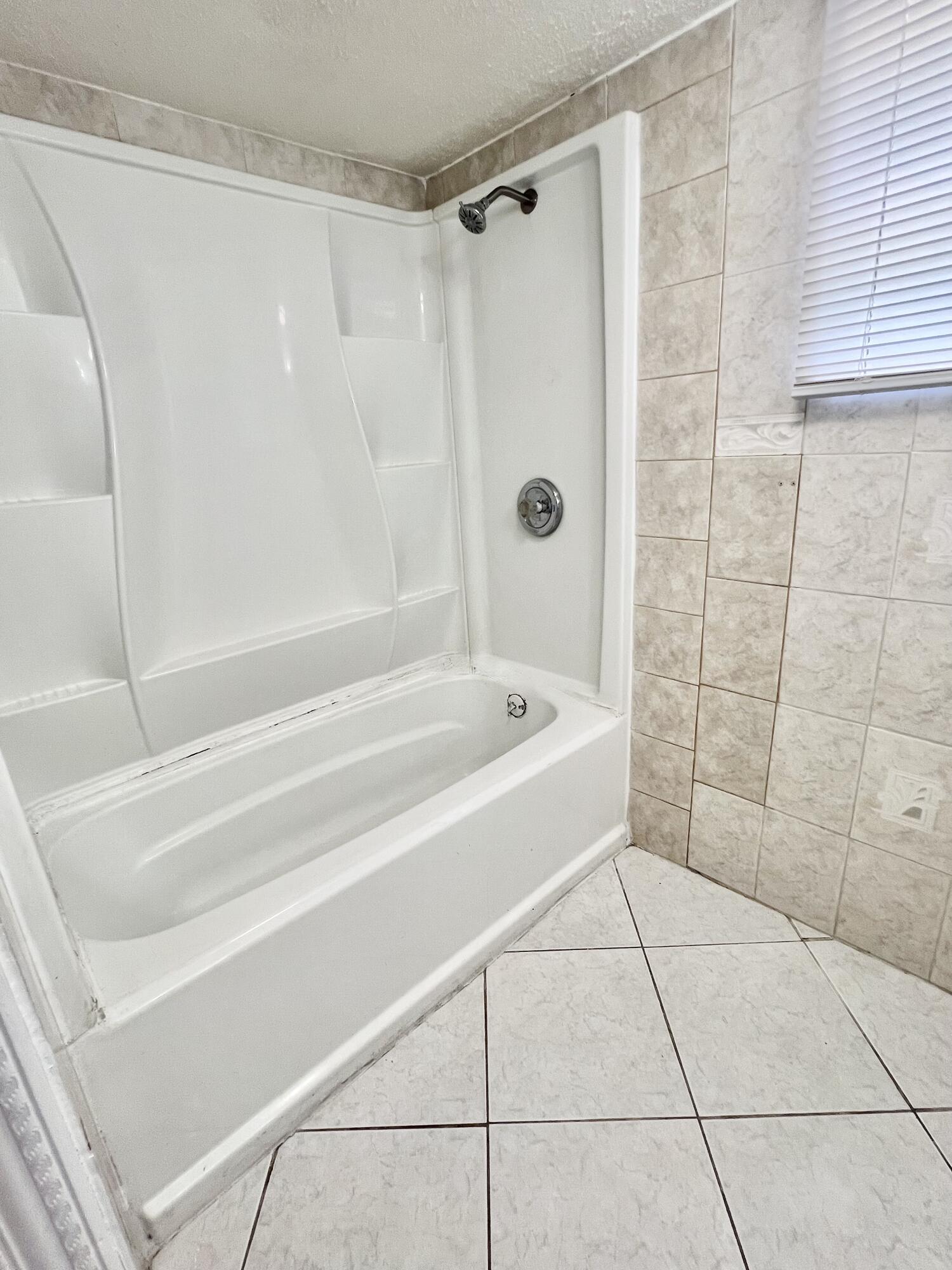 6129 Funston Street Hollywood, FL 33023 - Photo 11 of 18 a bathroom with a bathtub and shower