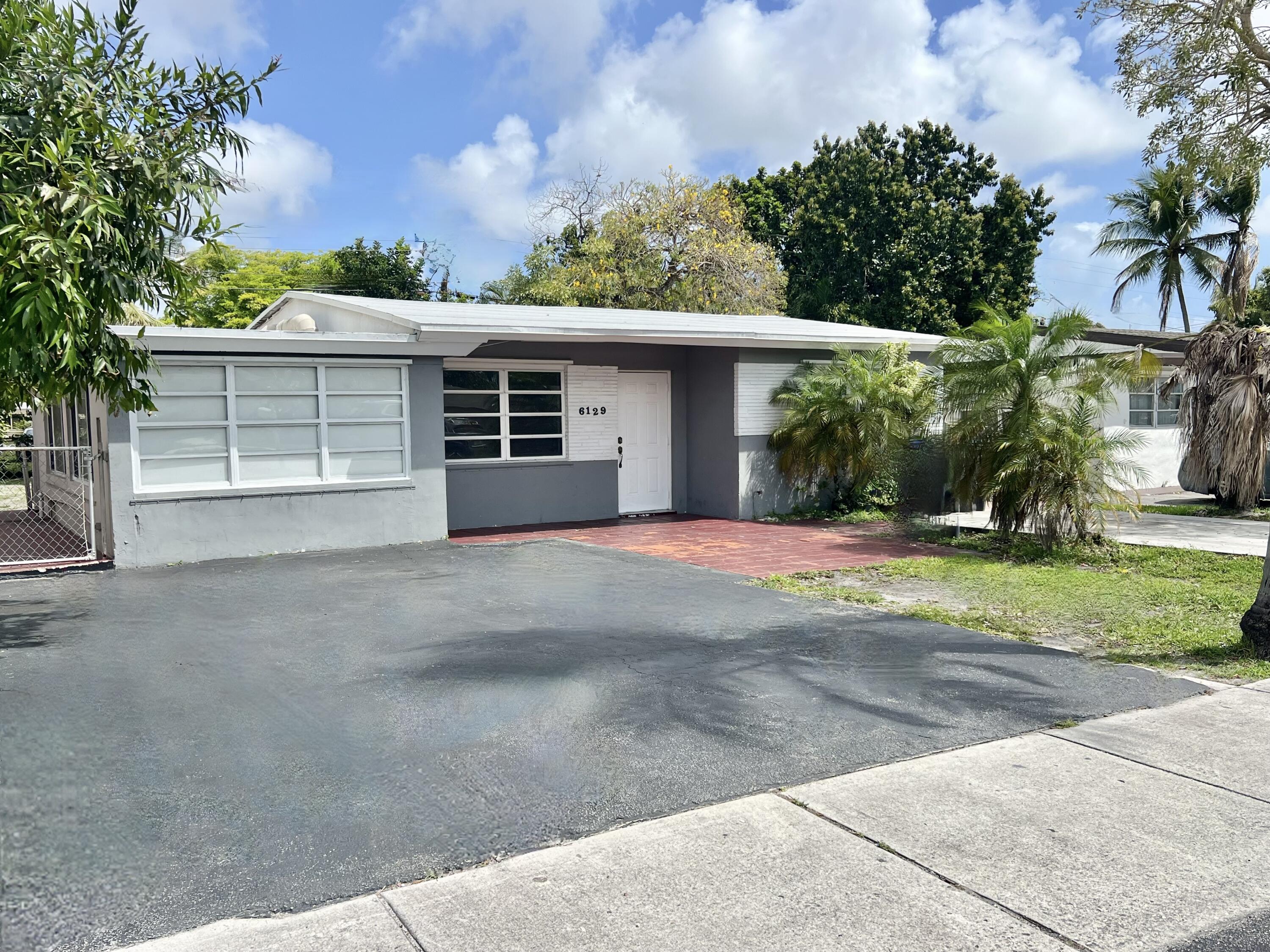 6129 Funston Street Hollywood, FL 33023 - Photo 2 of 18 front view of a house with a yard