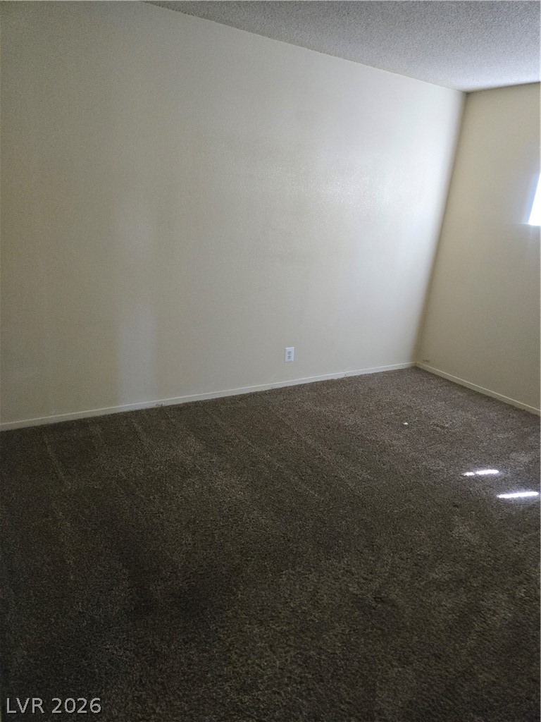 1388 East Desert Inn Road, Unit 2 Las Vegas, NV 89169 - Photo 8 of 23 Ascend effortlessly on this carpeted stairway, bathed in natural light from above.
