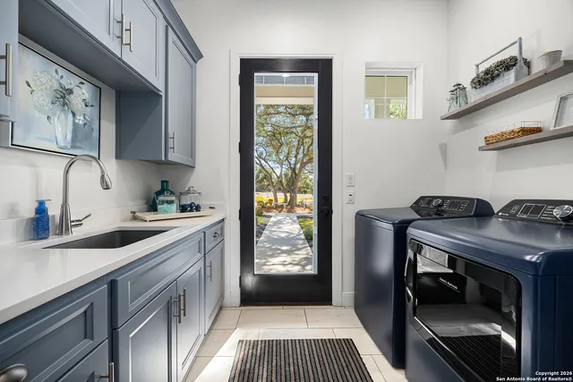 a bathroom with a granite countertop double vanity sink a mirror and a bathtub